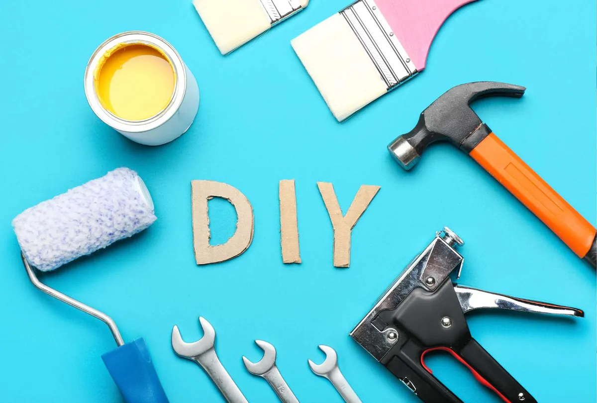 Frame Made of Tools and Word DIY on Color Background