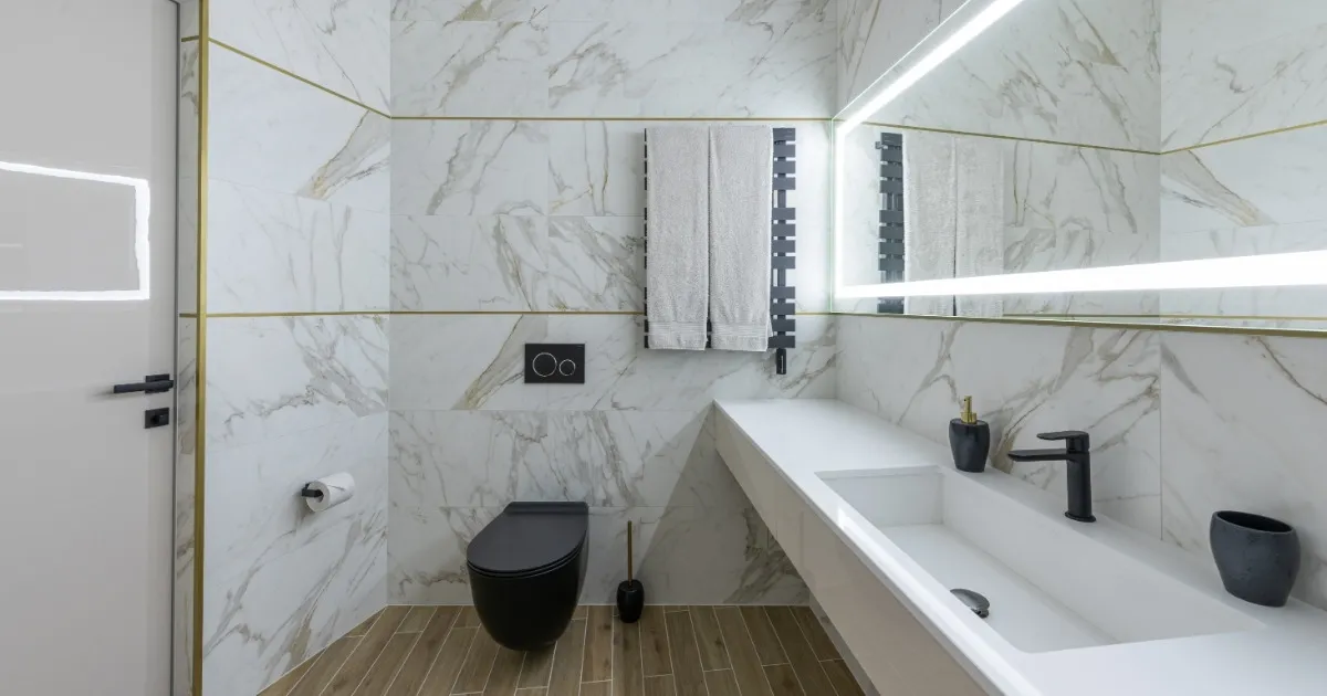 Interior of modern light bathroom with parquet floor and marble walls