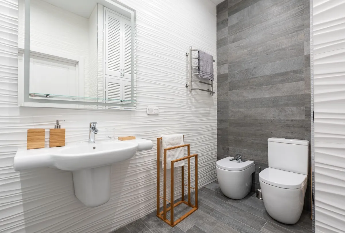 Contemporary bathroom interior with washbasin and toilet bowl