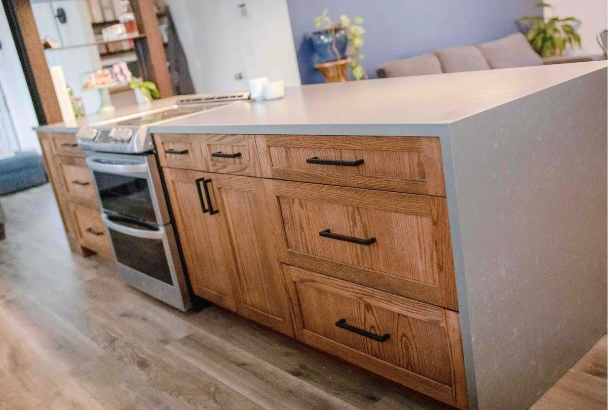 kitchen island with a countertop and warm wood cabinets