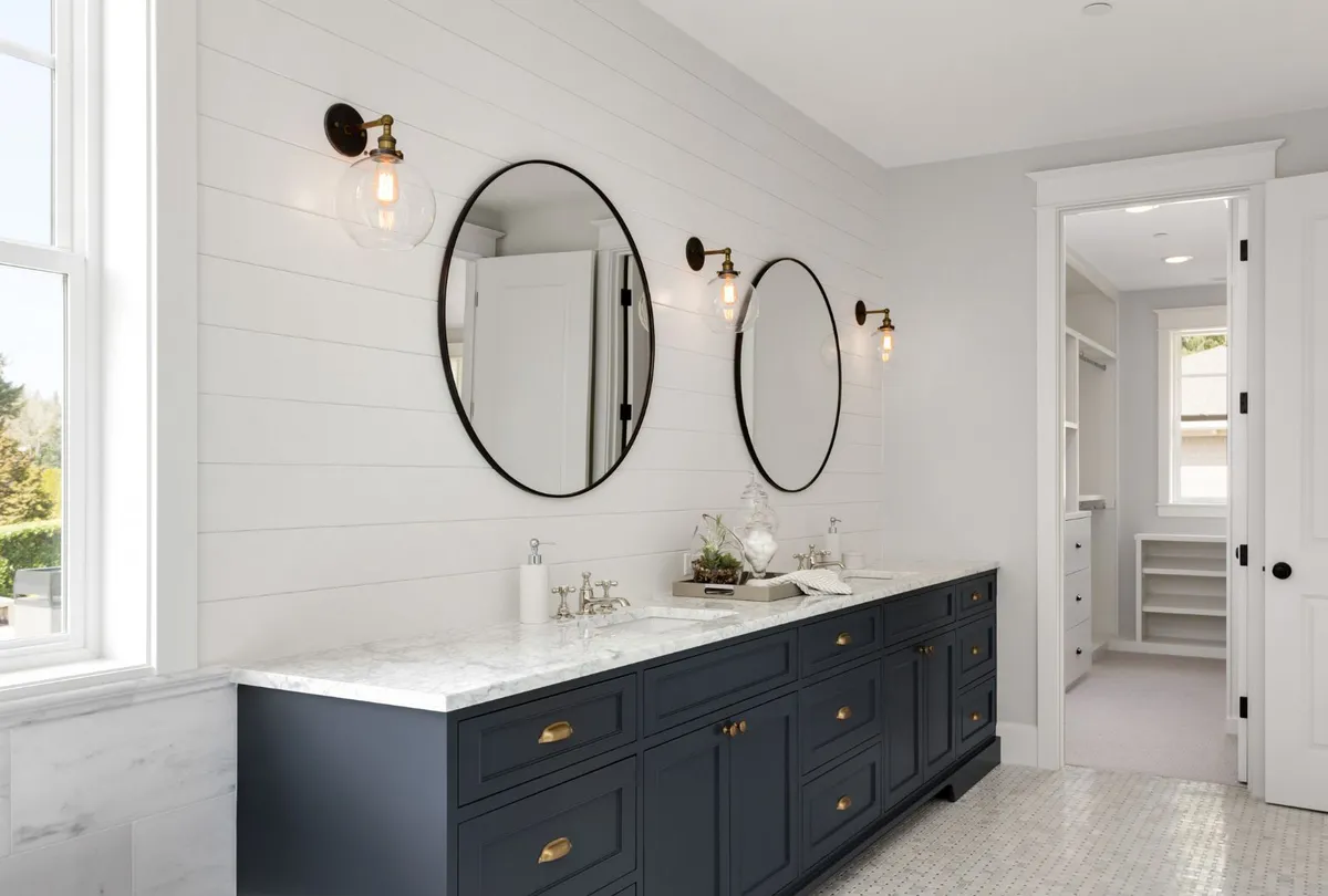 Bathroom in New Luxury Home with Two Sinks and Wall Sconces